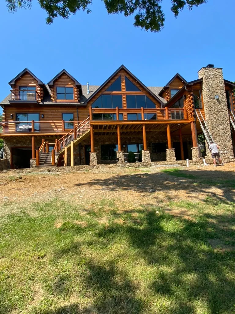 Finished exterior wood deck and railing on a log home